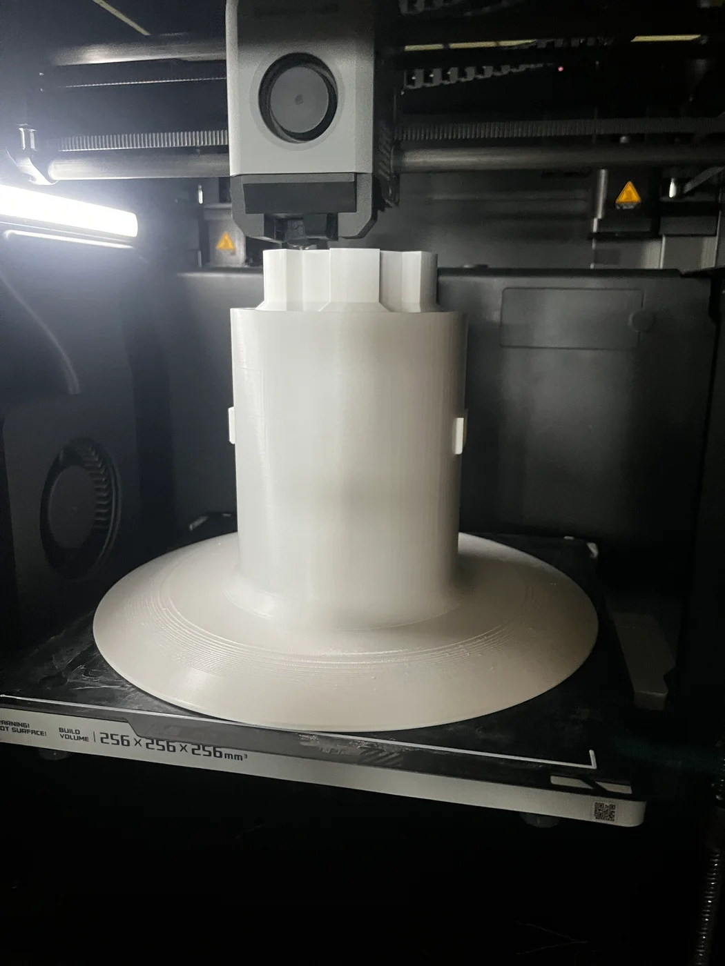 White electric fence reel spool being manufactured on a 3D printer