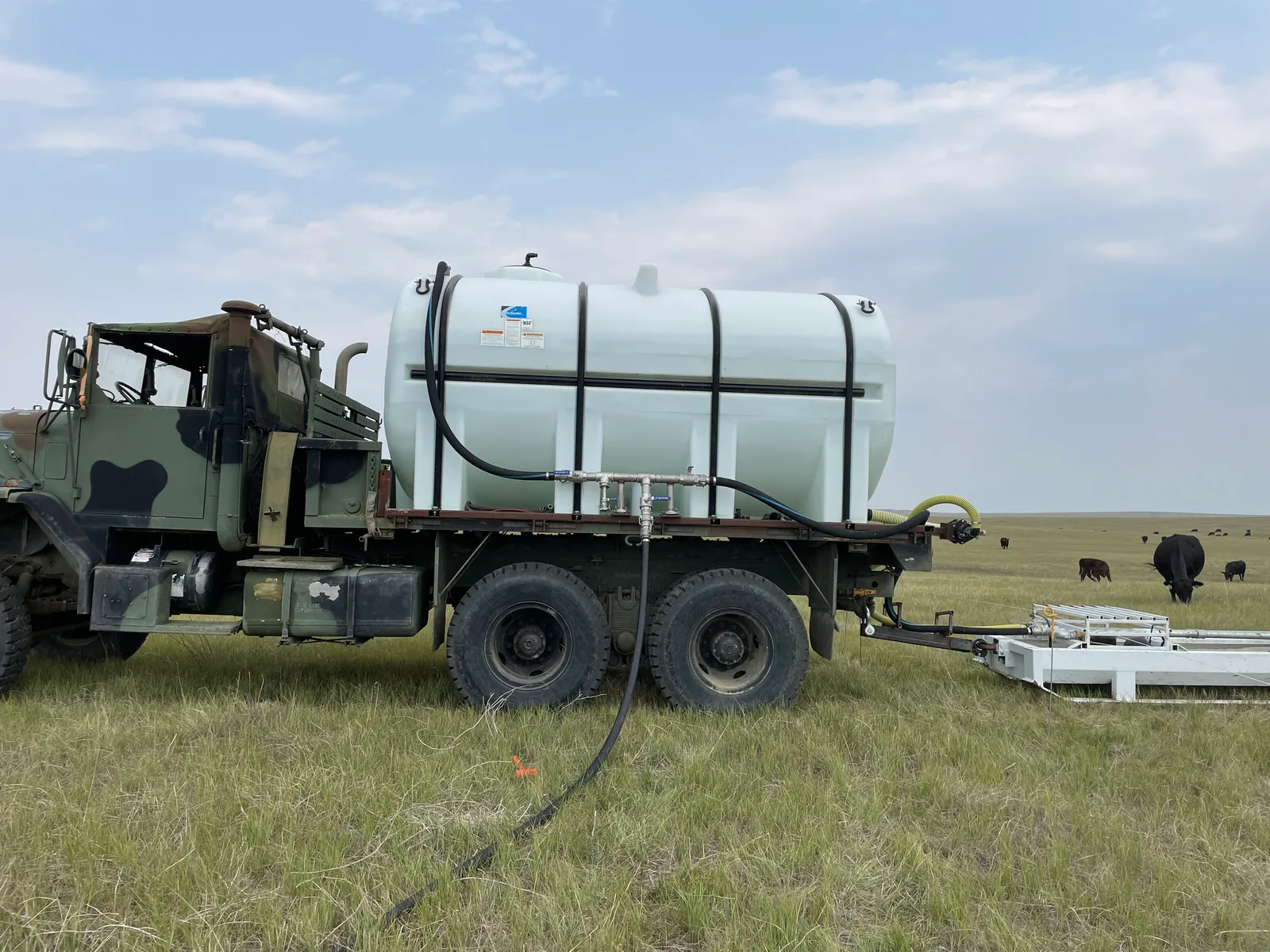 Portable livestock water trough beside a ranch utility vehicle