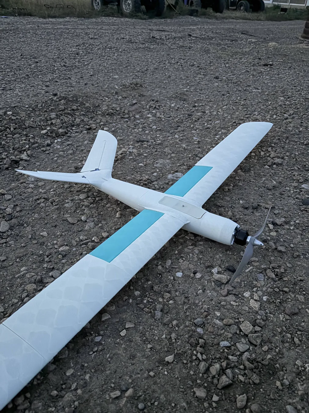 White and blue 3D-printed RC airplane prototype outdoors