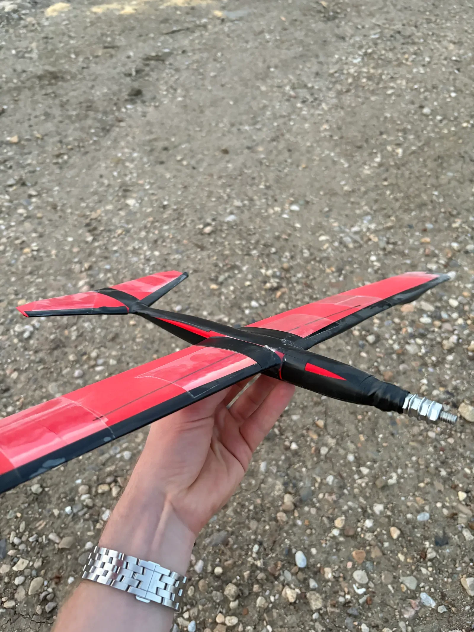Small red and black printed glider used to learn basic aerodynamics